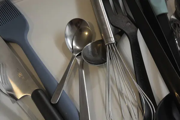 Kitchen utensils, all items like: forks, spoons, ladles, sieve, ladles, whisks, knives, spatula and many more that we usually use when preparing meals and breakfasts.