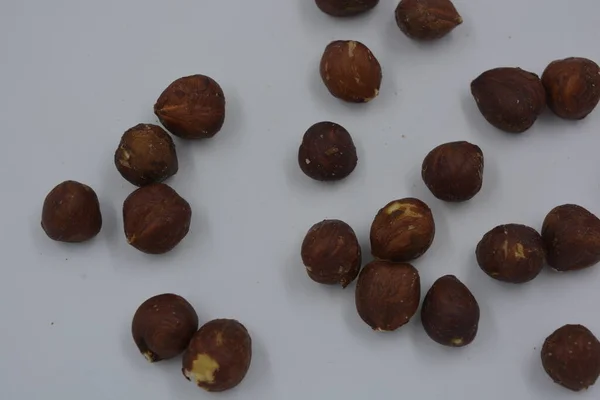 Wholesome and healthy food, natural nuts, large hazelnuts arranged on a white background.