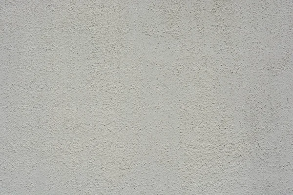 Building materials, street wall cladding, coating in the form of a white rough structure.