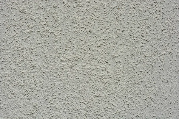 Building materials, street wall cladding, coating in the form of a white rough structure.