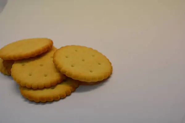 Breakfast, delicious and healthy foods, salty biscuits, round crackers arranged on a white background.