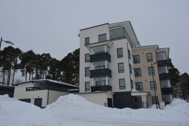 Varkaus, Finlandiya 'da bulunan bir gölün yakınındaki güzel ve şık binalar, Noel ağaçları ve ağaçlarla dolu yapılar..