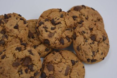 Şekerler, lezzetli çikolatalı kurabiyeler. Beyaz arka planda büyük boy sütlü ve koyu çikolatalı..