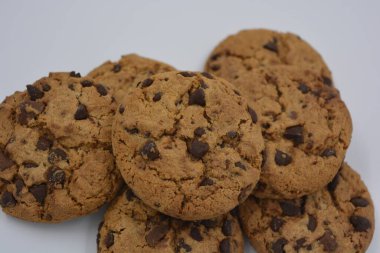 Şekerler, lezzetli çikolatalı kurabiyeler. Beyaz arka planda büyük boy sütlü ve koyu çikolatalı..