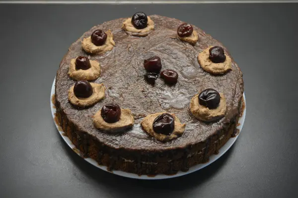 Cuisine, homemade cakes, delicious confectionery. Unusual sponge cake with buttercream and cherries Drunken cherry.