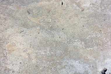 İnşaat malzemeleri, gri orijinal çimento, açık kahverengi arka plan, küçük düzensizlikler ve oyuklar..