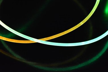 Güzel ve alışılmadık grafik arka plan. Çok renkli ışık, ışık demetleri plastik bükülmüş borulardan geçiyor. Parlayan plastik, kırmızı, sarı, beyaz, mor, yeşil, turuncu, mavi, taşmış ve açık mavi.