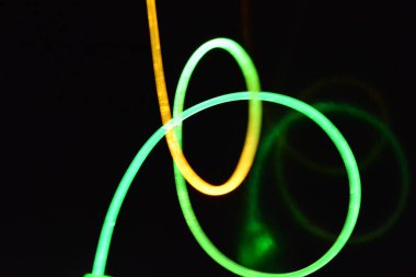 Güzel ve alışılmadık grafik arka plan. Çok renkli ışık, ışık demetleri plastik bükülmüş borulardan geçiyor. Parlayan plastik, kırmızı, sarı, beyaz, mor, yeşil, turuncu, mavi, taşmış ve açık mavi.