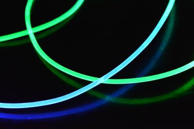 Güzel ve alışılmadık grafik arka plan. Çok renkli ışık, ışık demetleri plastik bükülmüş borulardan geçiyor. Parlayan plastik, kırmızı, sarı, beyaz, mor, yeşil, turuncu, mavi, taşmış ve açık mavi.