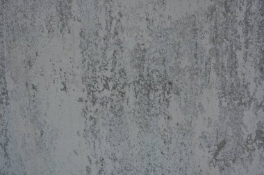 Original background, building materials, gray cement walls covered with light brush strokes with white paint. Building materials, gray original cement, light brown background with small irregularities and hollows.