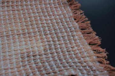 Yumuşak kumaşlar, eşyalar, siyah ve beyaz ağarmış pamuk peçeteler siyah plastik arka planda yer alır..