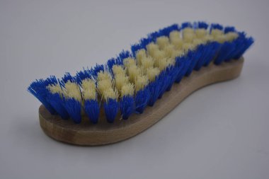 Ev için günlük eşyalar, ev eşyaları beyaz plastik arka planda bulunur. Finlandiya 'da doğal ahşap, beyaz ve mavi tüylerden yapılmış fırça temizleme halıları gibi şeyler..