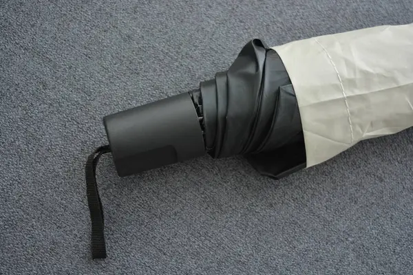 An old red metal bicycle stands against a white fence, on a green lawn. The bicycle parts are old, the bicycle wheels are rusty, there are many red spots of rust on the metal parts of the bicycle.
