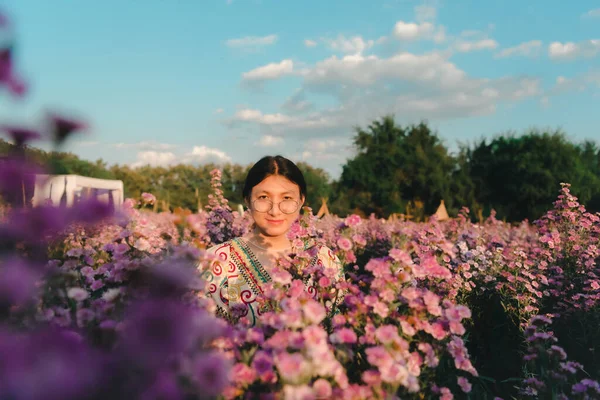 stock image Beautiful asian woman (LGBTQ) natural makeup wear fashion relax clothes posing at nature of flower park or flower garden field lush growing for travel popular landmark in asia outdoor fashion style