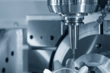 The 5-axis CNC milling machine  cutting the metal gear part. The hi-technology automotive part manufacturing process by CNC lathe.