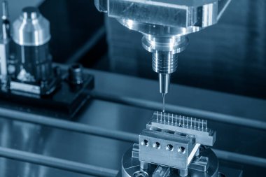 The CNC milling machine cutting the copper electrode parts with solid ball end mill. The mold and die manufacturing process by CNC machining center.