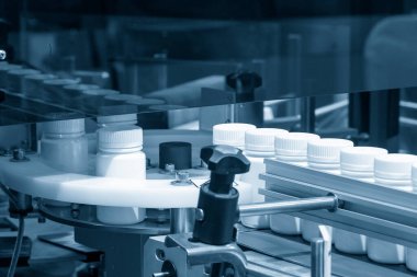 The drug filling process in the plastic bottle. The medical manufacturing process in medical factory.