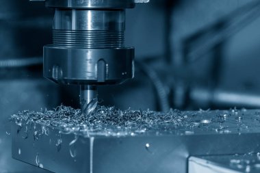 The drilling process on NC milling machine with coolant method. The metal working concept on the milling machine.