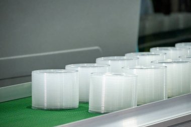 The pile of coffee cup lid make from the injection process. The drinking cup lid manufacturing concept by injection machine. 