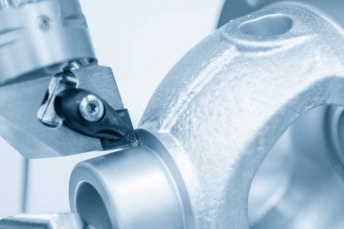 Close up scene the  chip insert  cutting the casting aluminum material parts. The hi-technology metal working processing by CNC turning machine .