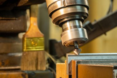 The chamfering process with the metal plate parts on NC milling machine.  The shop floor milling operation by milling machine