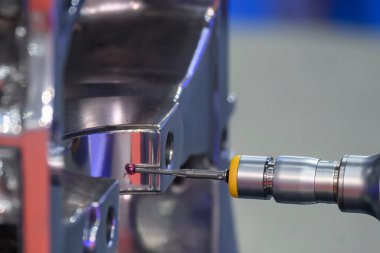 The  multi-axis CMM machine measuring the aluminum cylinder head parts . The quality control of automotive parts with multi axis CMM machine