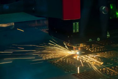 Close-up scene the fiber laser cutting machine cutting  machine cut the metal plate. The hi-technology sheet metal manufacturing process by laser cutting machine. 