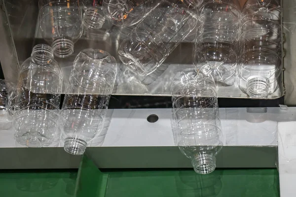 The hi-technology of drinking water manufacturing process. The  empty drinking water bottles  on the conveyor belt for filling process.