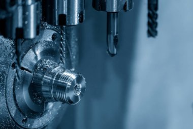 The multi-tasking CNC lathe machine swiss type tapping the metal pipe connector parts. The high technology metal working with CNC turning machine.