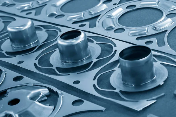 The close up scene of product parts from progressive die. The sample of metal forming by progressive die.