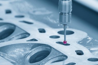 The CMM machine measuring the aluminum cylinder head parts . The quality control of automotive parts with multi axis CMM machine