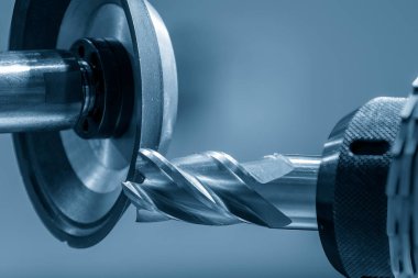 Close up scene the flat end mill tool regrinding process on regrinding machine. The tool regrinding process for CNC milling machine.