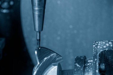 Close up the 5 axis machining center cutting the boat propeller parts  parts with taper ball end mill tool. The hi-precision parts  manufacturing process by multi-axis CNC milling machine.