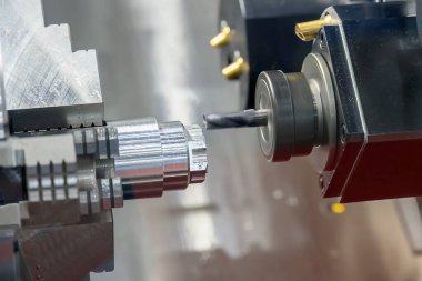 The multi-tasking CNC lathe machine  milling cut the metal shaft parts by milling turret. The high technology metal working with CNC turning machine.