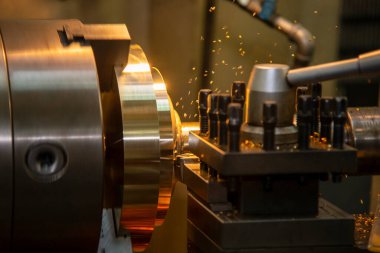 Closeup scene the lathe machine finish cut the brass parts by lathe tools. The metalworking process by turning machine.