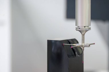 The  CMM machine measuring the graphite electrode parts . The quality control of mold and die manufacturing process with multi axis CMM machine