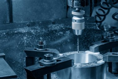 The drilling process on NC milling machine with brass material. The metal working concept on the milling machine.