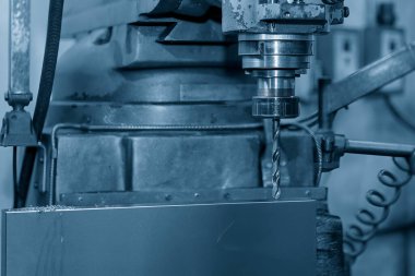 The drilling process on NC milling machine with brass material. The metal working concept on the milling machine.