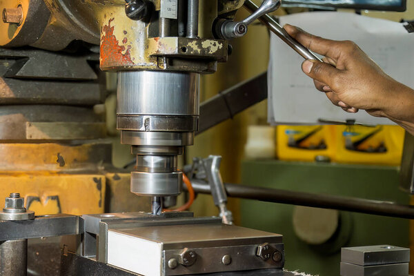 The drilling process on NC milling machine by skill operator. The metal working concept on the milling machine.