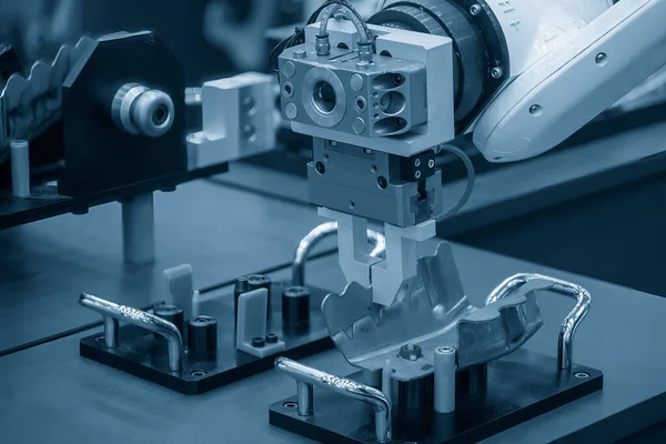 stock image The hi-technology  material handling process by robotic system in sheet metal process . The automatic  robotic arm gripping the sheet metal parts. 