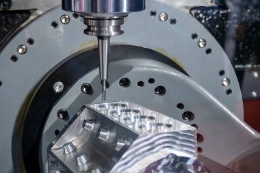 Close up scene the 5-axis machining center cutting the V8 engine cylinder block with solid ball end mill tool. The hi-precision automotive manufacturing process by multi-axis CNC milling machine.