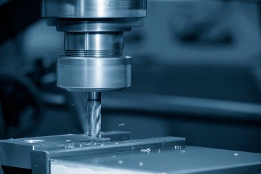 The drilling process on NC milling machine with brass material. The metal working concept on the milling machine.