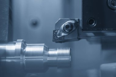 CNC torna makinesi metal çivi parçalarının sonunda iplik kesiyor. CNC dönüşüm makinesinin yüksek teknolojili metal işlemesi .