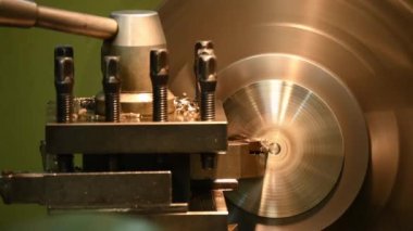 Closeup scene the lathe machine finish cut the brass parts by lathe tools. The metalworking process by turning machine.