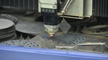 Close-up scene the fiber laser cutting machine cutting  machine cut the metal plate. The hi-technology sheet metal manufacturing process by laser cutting machine. 