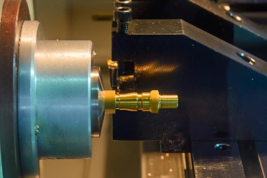 CNC Torna Makinesi sahnesini kapatın pirinç boru bağlantı bölümlerinin sonundaki ipliği kesin. CNC dönüşüm makinesinin yüksek teknolojili metal işlemesi .