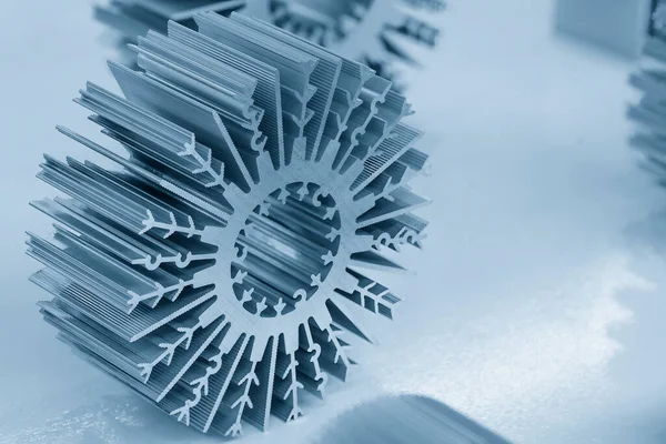 The sample parts of aluminum profile extrusion manufacturing concept. The circular shape of aluminum heat sink profile.