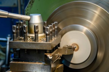 Closeup scene the lathe machine finish cut the brass parts by lathe tools. The metalworking process by turning machine.
