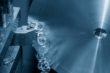 Closeup scene the lathe machine finish cut the brass parts by lathe tools. The metalworking process by turning machine.