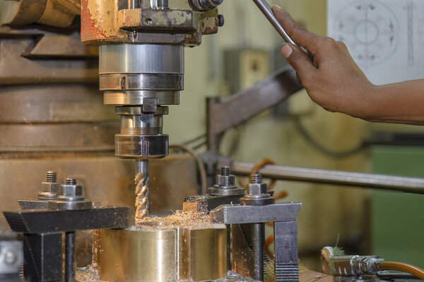 The plunge cutting  process on NC milling machine with flat end mill tools. The metal working concept on the milling machine.